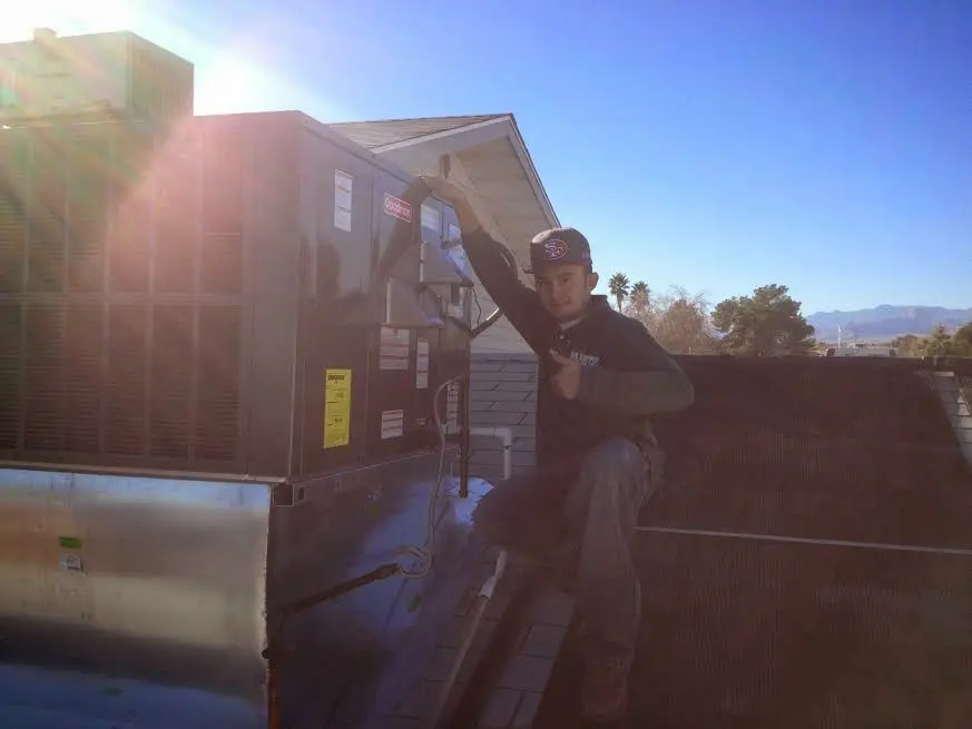 HVAC technician performing HVAC Inspection on a rooftop unit in Shaw Heights